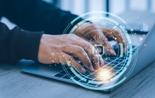 Person typing on a laptop with a glowing digital security interface