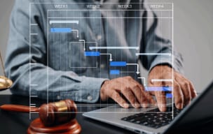 Person using a laptop with a digital Gantt chart overlay