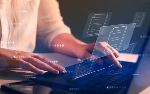 Person typing on a laptop with digital document icons floating above