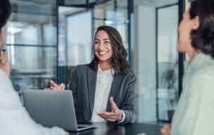Businesswoman smiling during a meeting with colleagues