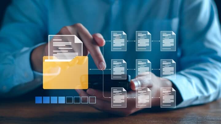 A person holding mobile phone and accessing digital folder