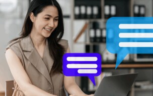 Woman smiling and typing on computer