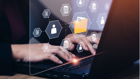 Hands typing on a laptop
