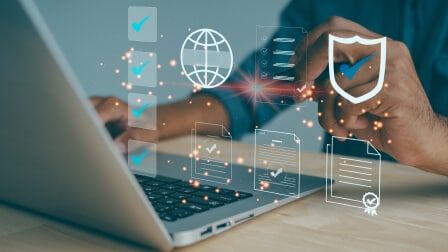 A person working on laptop with floating digital icons and a globe graphic