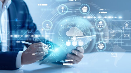 A person holding a tablet with a holographic cloud and tech network display