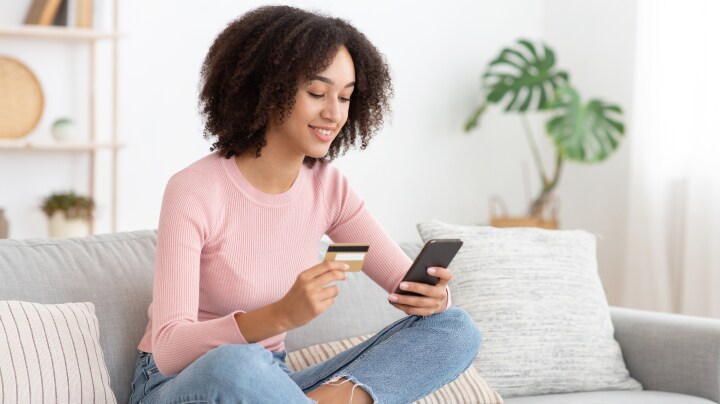 Person in their living room shopping on their phone