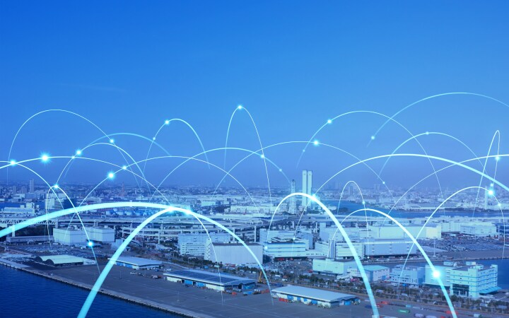 Cityscape with glowing curved lines representing digital connectivity