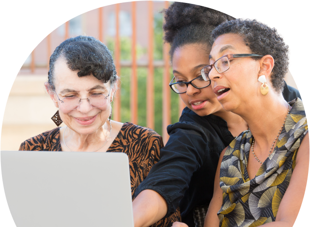 Three people working together on a laptop 