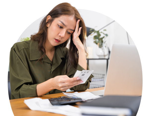 A person working on a laptop and processing invoices 