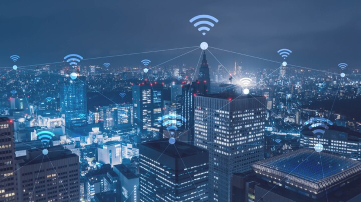 Wifi symbol hovering over buildings within a city 