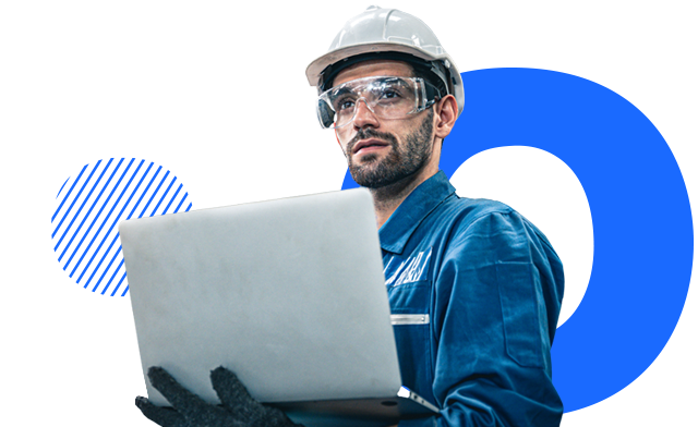 A person looking at a laptop in a manufacturing facility