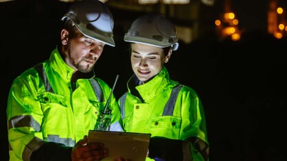 Two people looking at a tablet