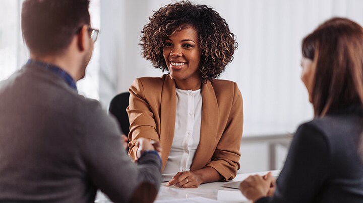 Three people having a conversation about a project