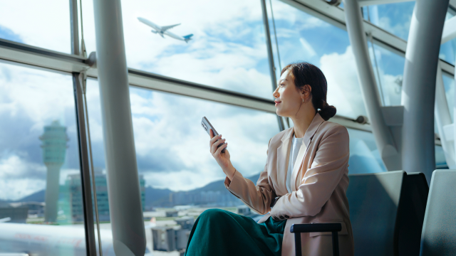 A person holding a phone in the airport