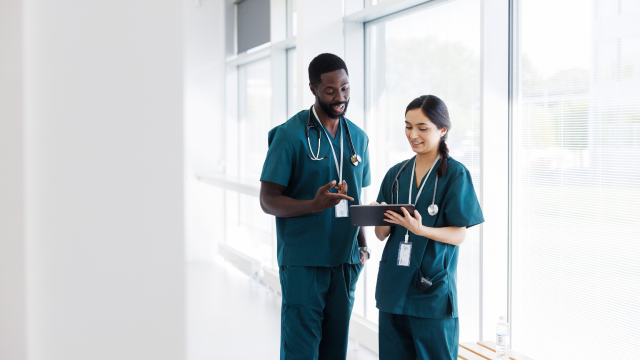 two doctors looking at a ipad