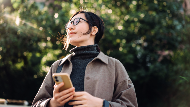 A person enjoying the outdoors with a phone in their hand