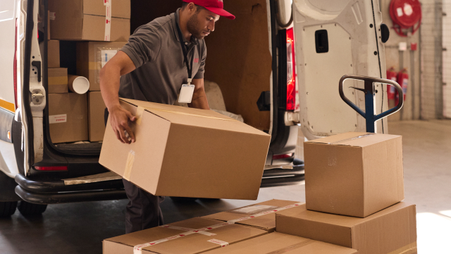 Delivery person unloading a product shipment
