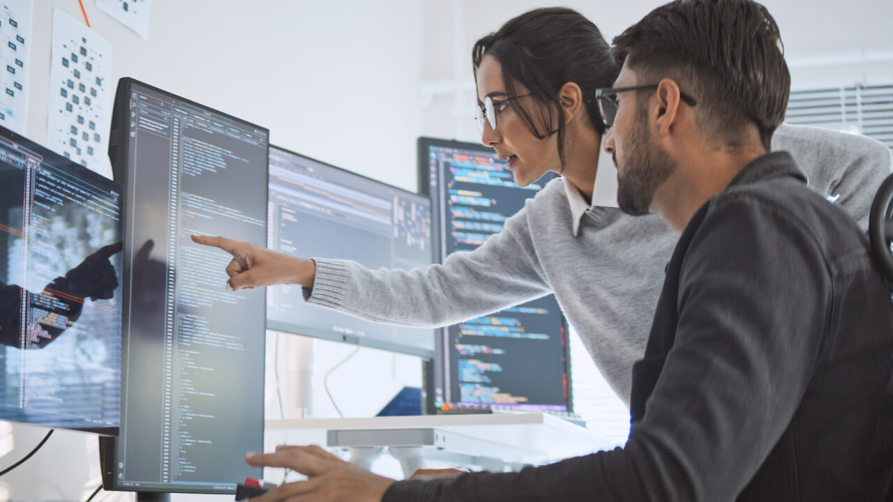 Two Person looking at computer screens