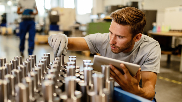 A Man inspecting products in factory