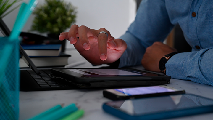 Person consuming content on multiple devices at their desk