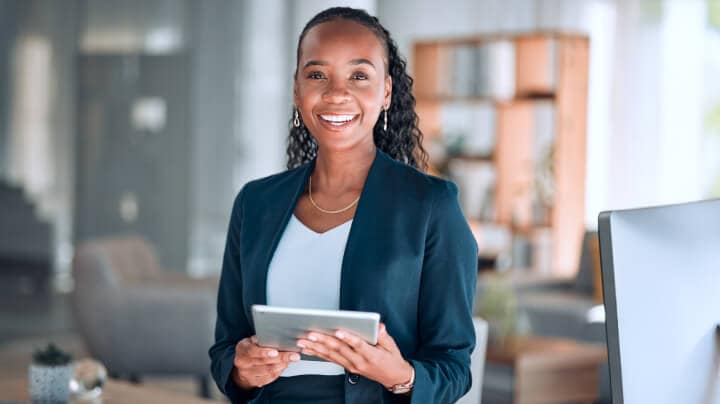 A person in an office working on a tablet.