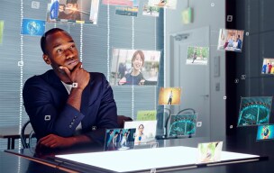 Man viewing floating digital images and data projections on a screen