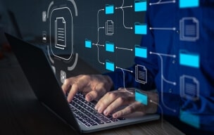 Hands typing on a laptop