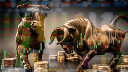 Bull statues with stacked coins and market charts in the background
